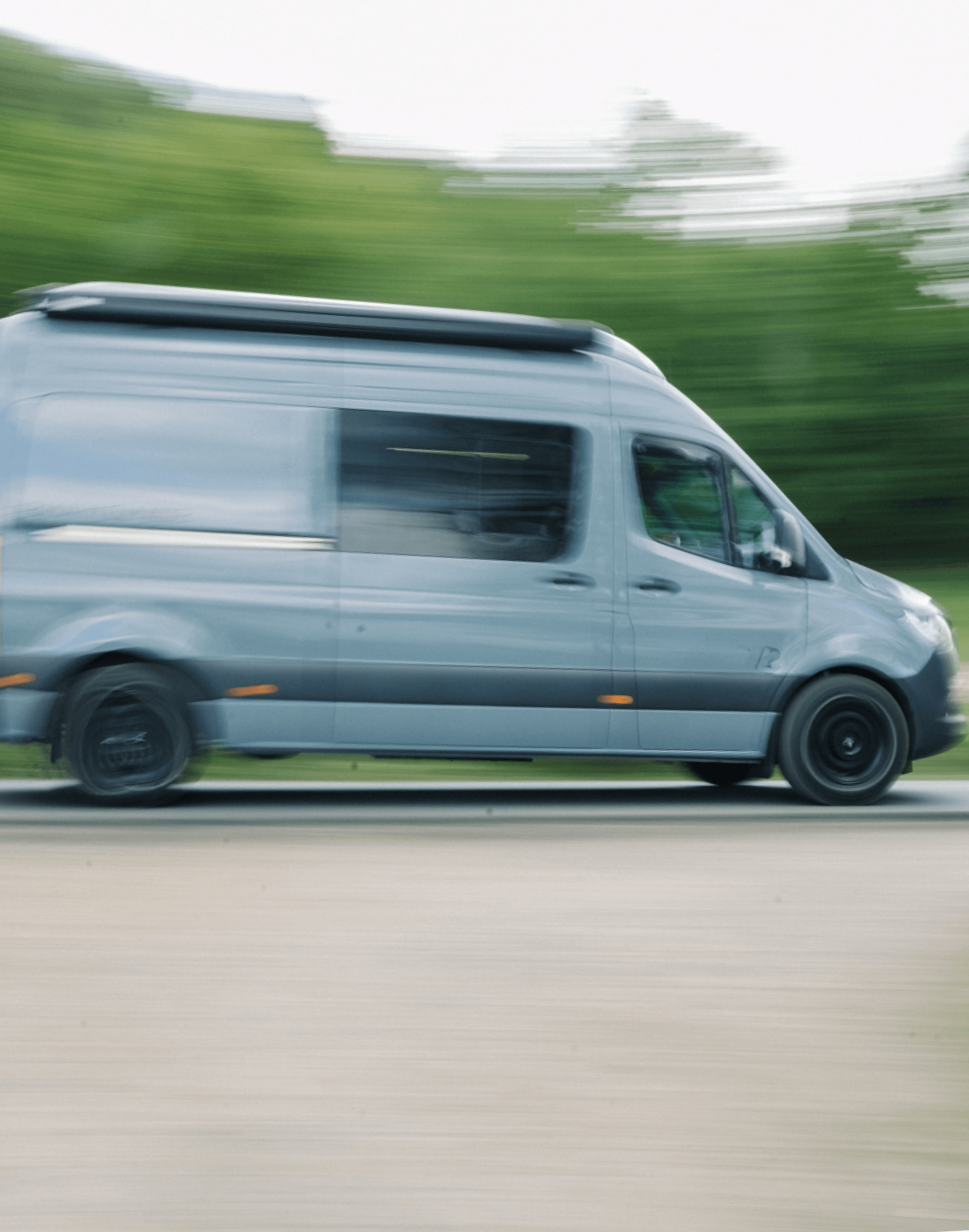 Aerial view of a campervan on a coastal road