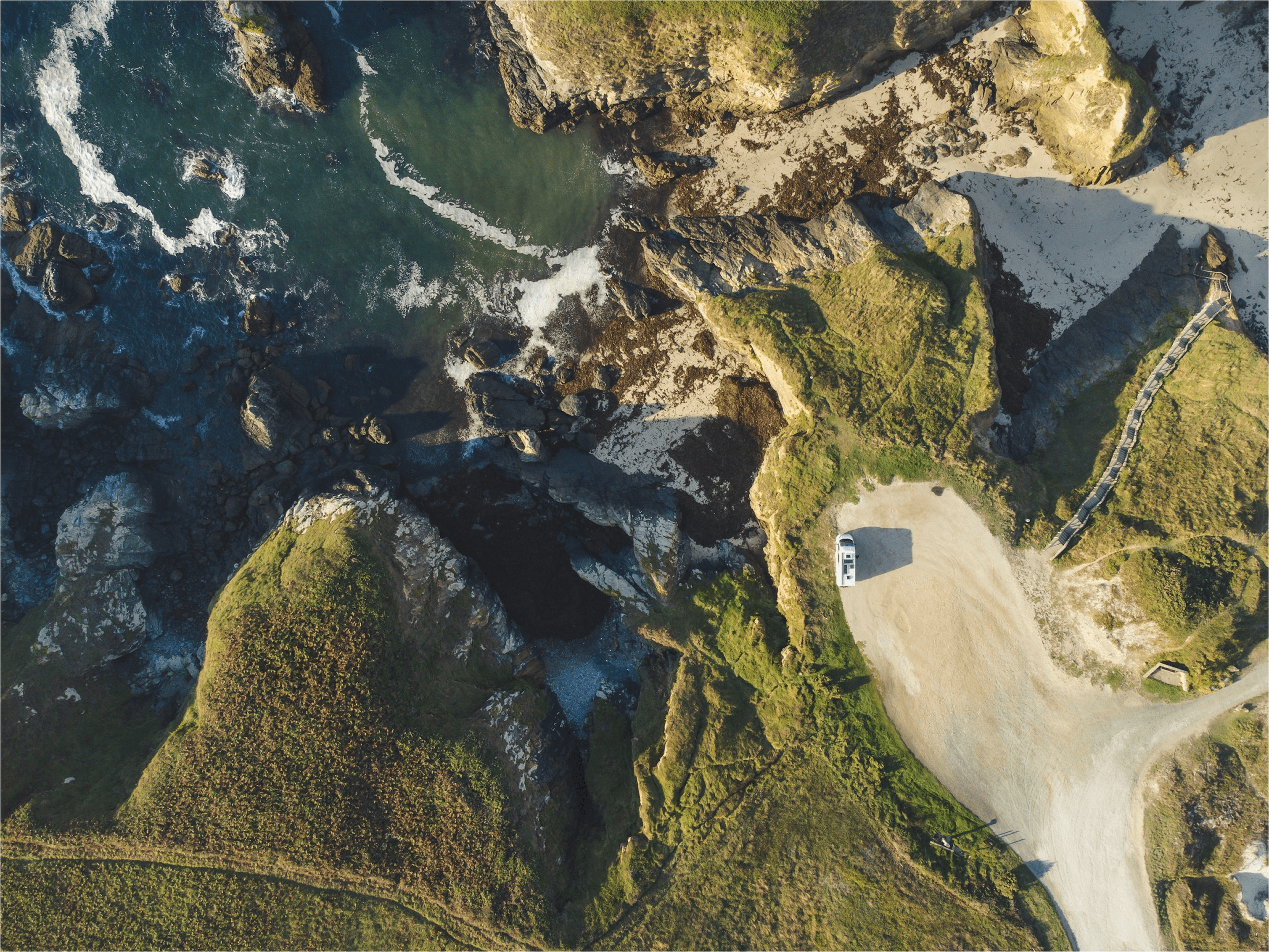 Coastal landscape with campervan from above
