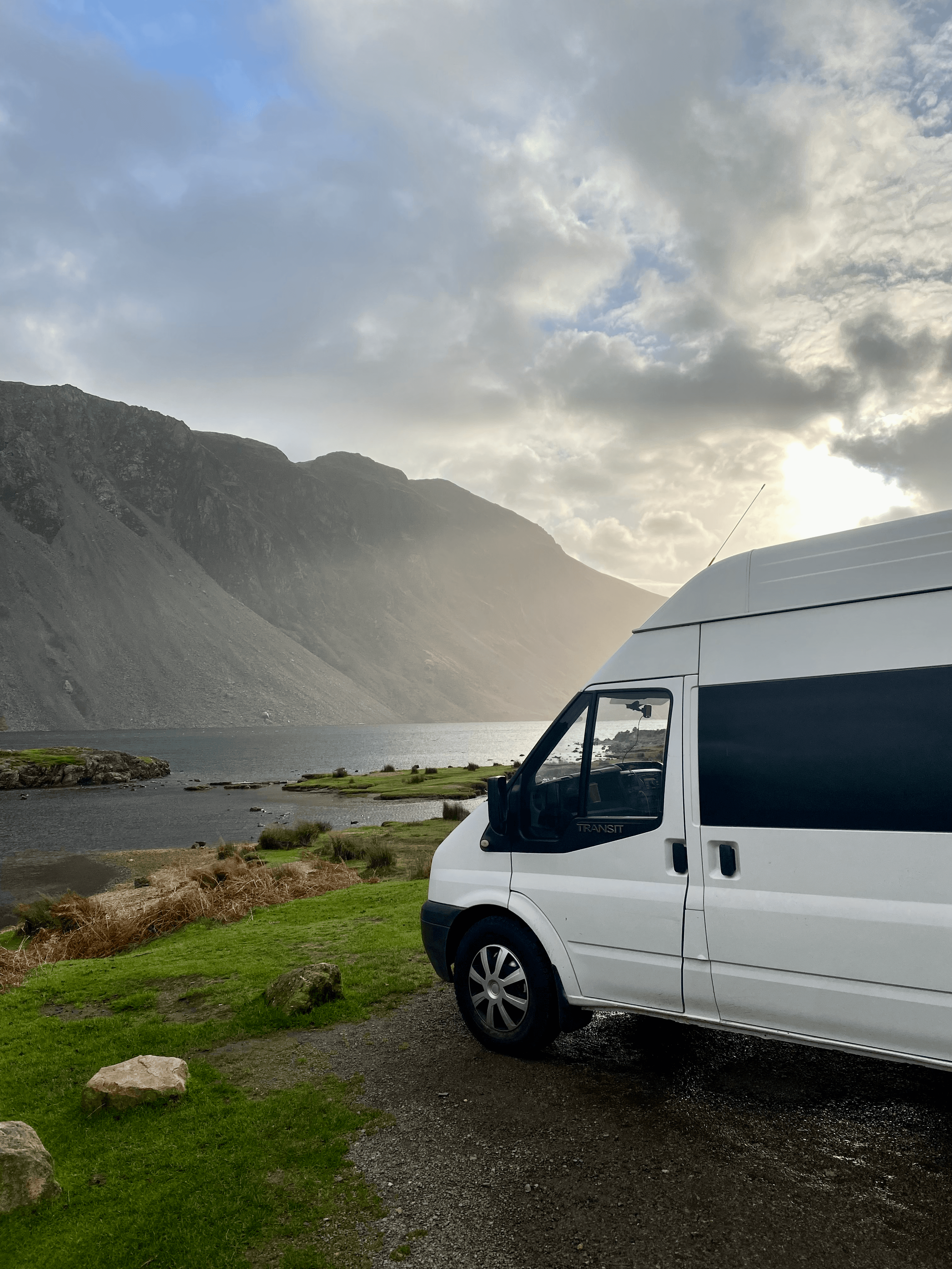 Campervan parked on edge of water